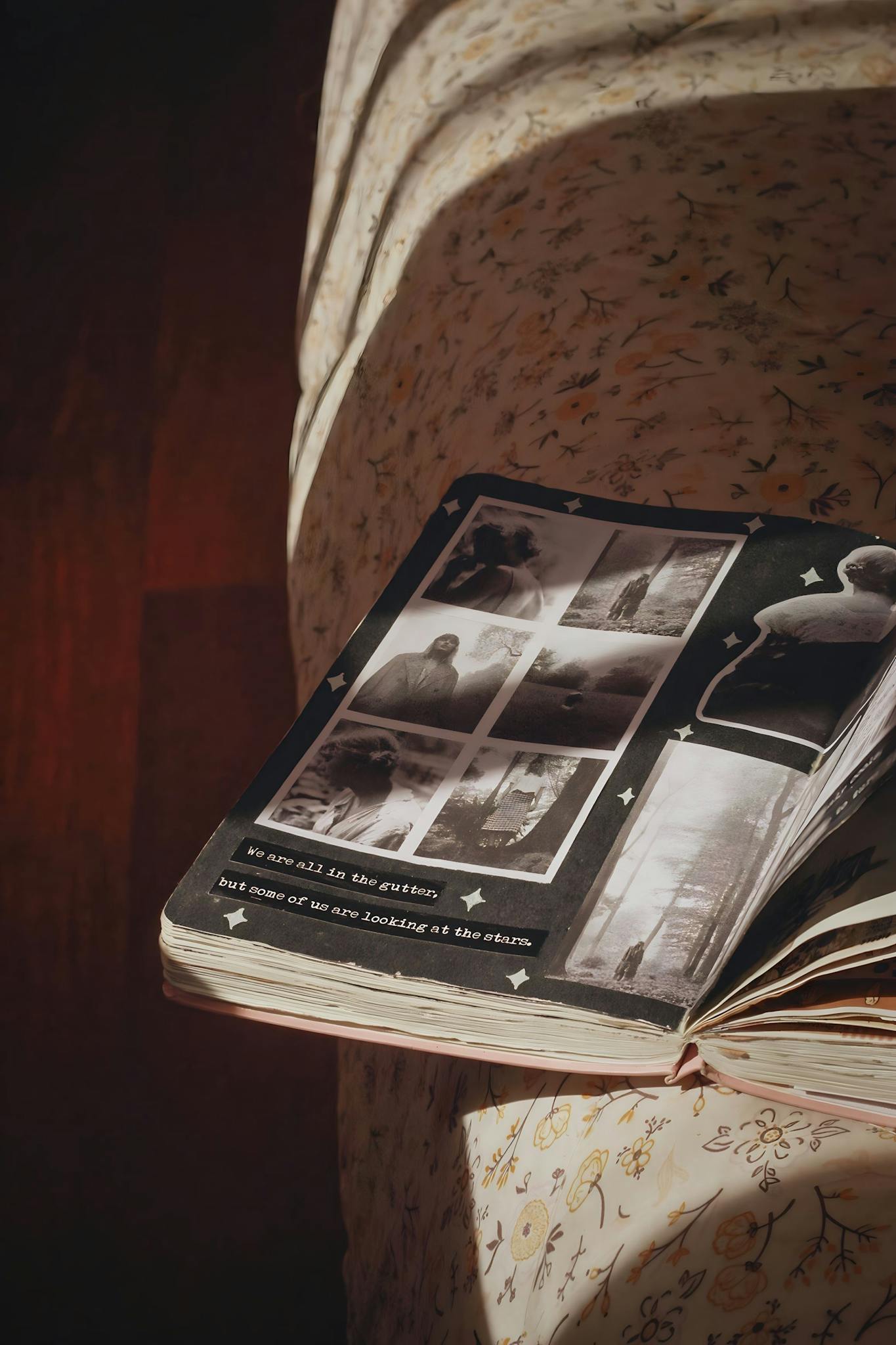 Open photo album with black and white nostalgic photographs in warm sunlight.